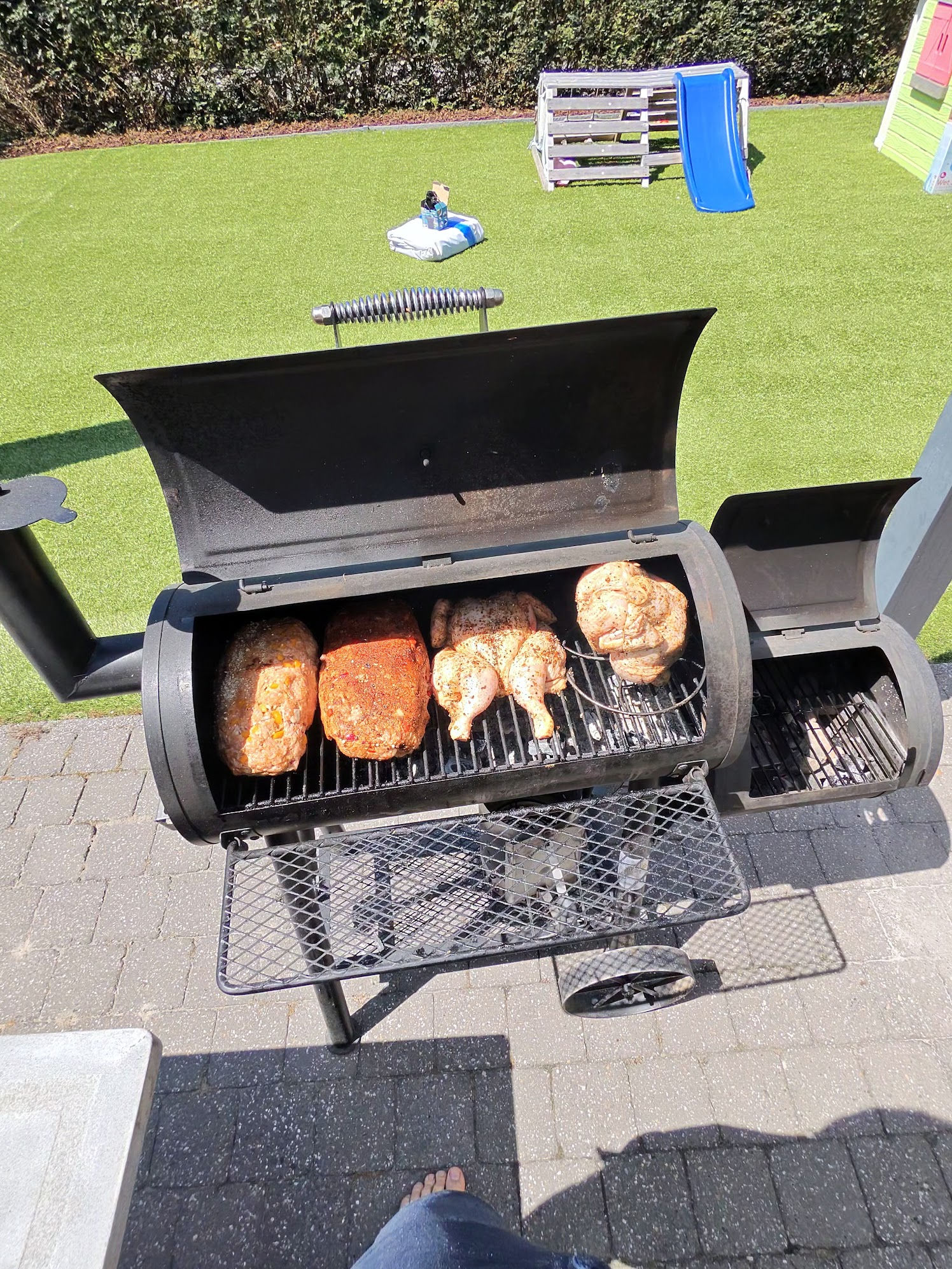 Smoker BBQ with meatloaf and chicken, shot from first-person perspective while wearing the glasses