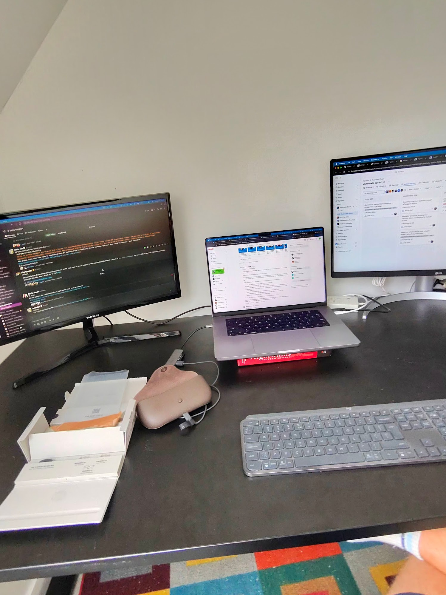 Desk setup with Ray-Ban glasses unboxing alongside work monitors